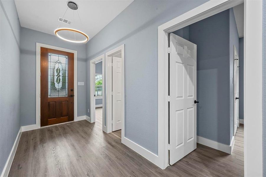 Foyer entrance with dark hardwood / wood-style floors