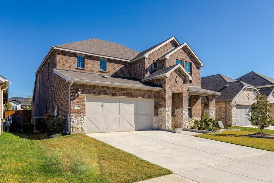 View of front of home with a garage and a front yard