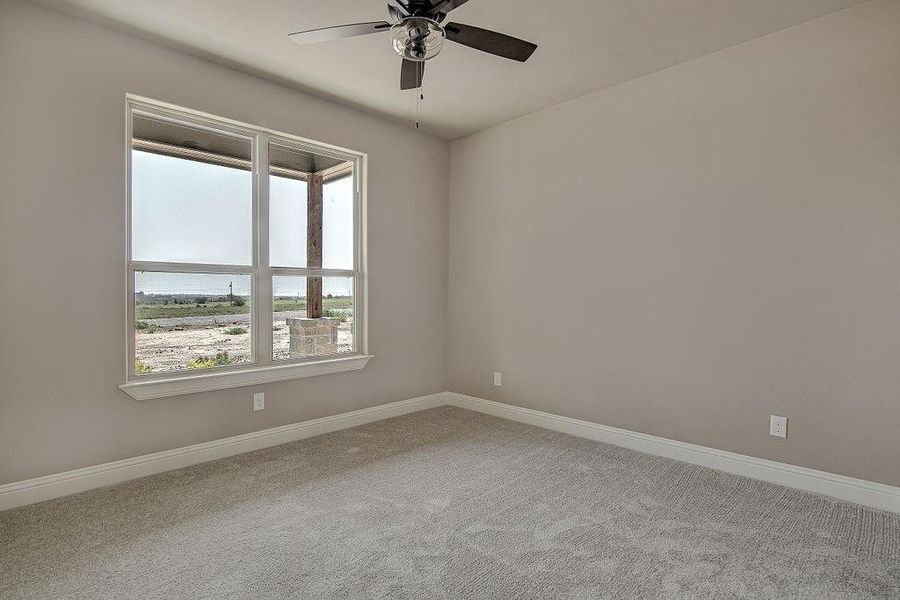 Unfurnished room with carpet and ceiling fan