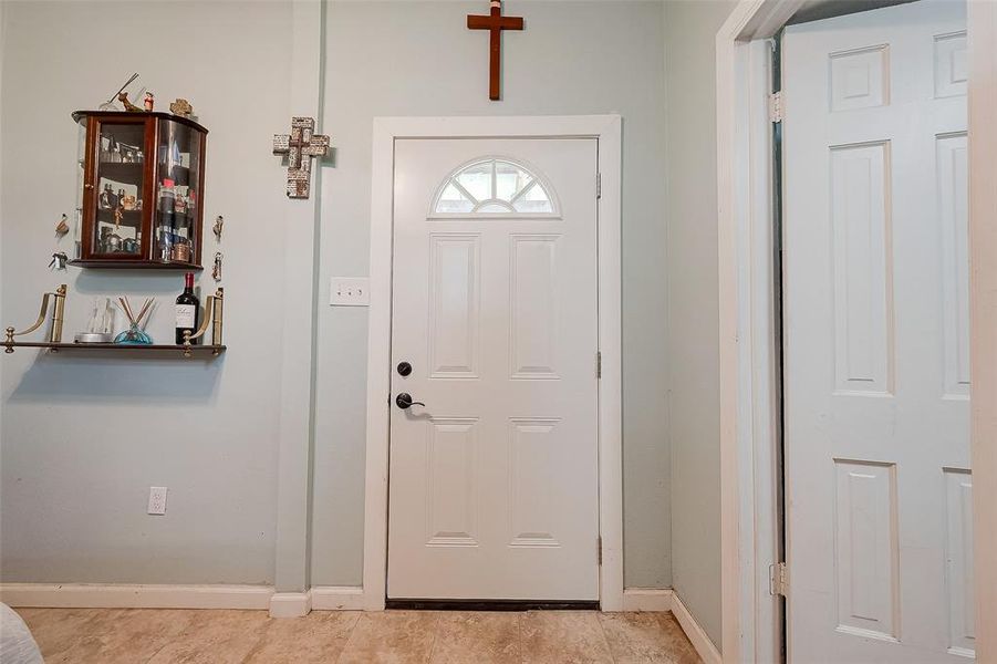 The bedroom features a white door with a mounted shelf and drawer, providing convenient storage for small items while maintaining a clean and organized space.