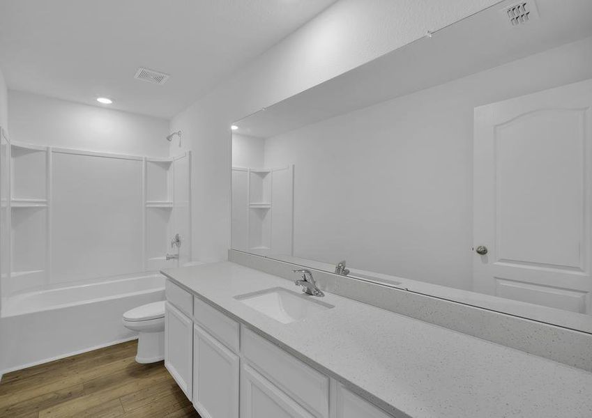 The guest bathroom has a spacious vanity