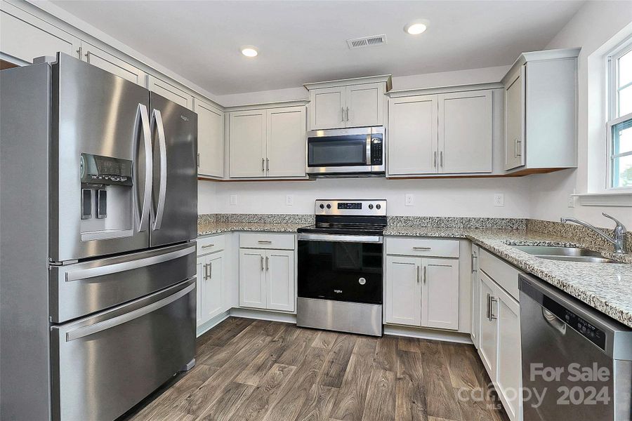 Modern kitchen with stainless steel appliances.