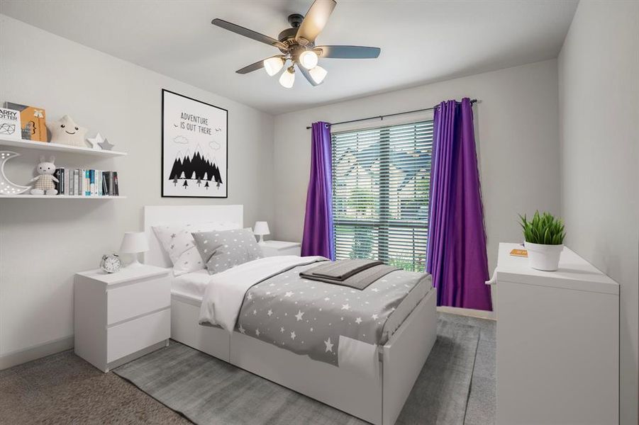 Located at the front of the home is the second downstairs bedroom with private full bathroom. It features plush carpet, neutral paint, a ceiling fan, and large windows letting in bright natural light. *This room has been virtually staged