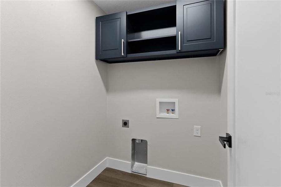 Indoor laundry with overhead cabinet