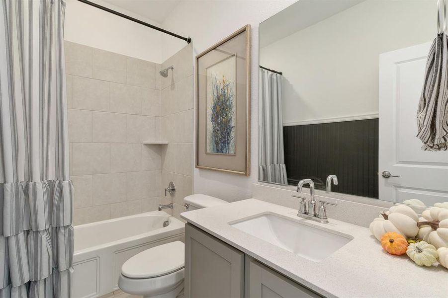 Full bathroom featuring vanity, shower / bath combo, and toilet