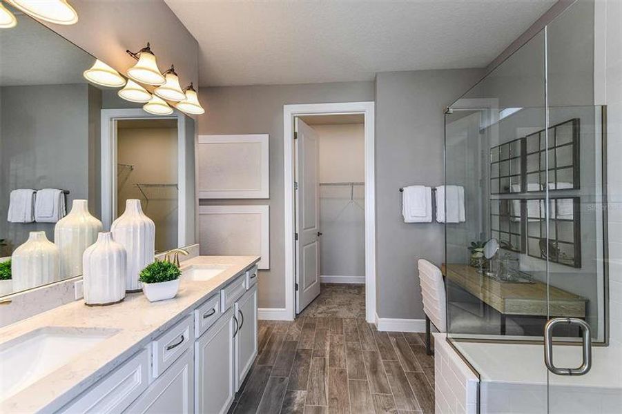 Owner's En Suite Bathroom and Walk-in Closet. Model home design. Pictures are for illustration purposes only. Elevations, colors and options may vary. Furniture is for model home only.