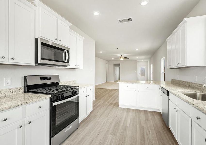 The chef ready kitchen has stainless steel appliances and white cabinets.