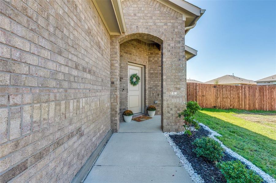 Doorway to property with a lawn