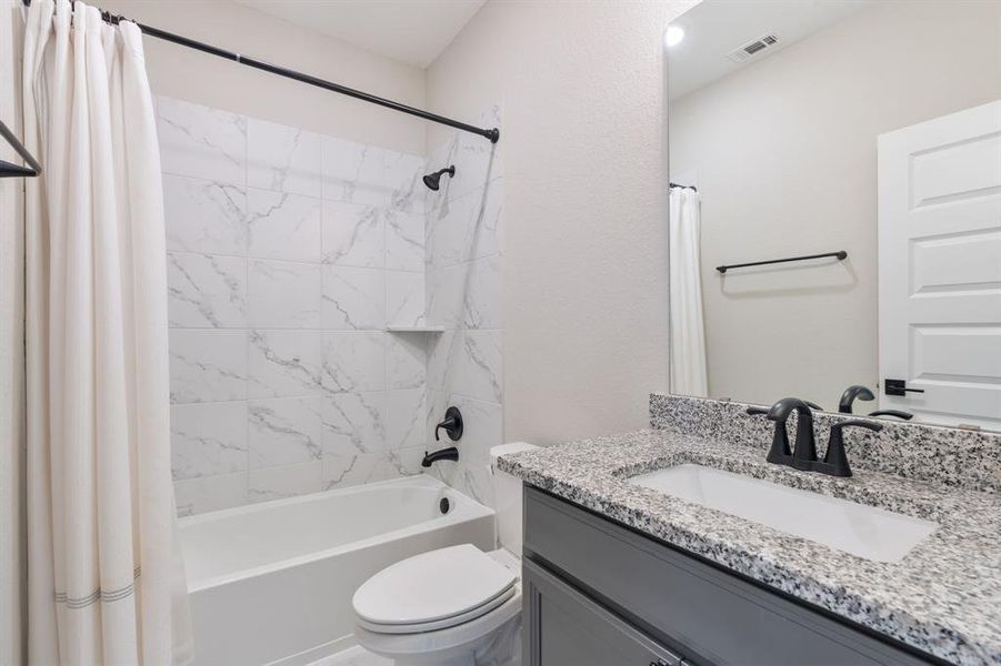 Second floor hall bath located between bedroom three and four. All bathrooms feature granite countertops.