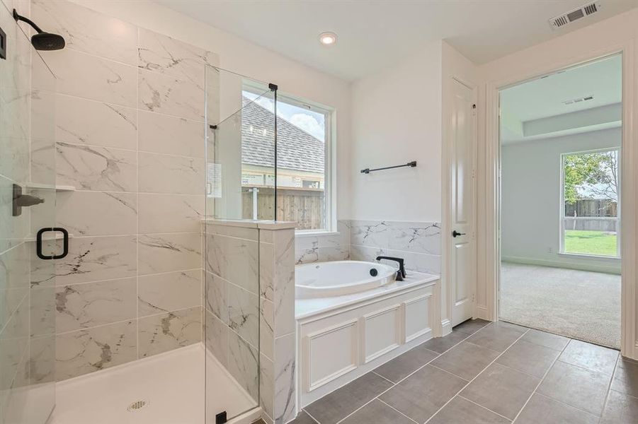 Bathroom featuring separate shower and tub and tile patterned floors