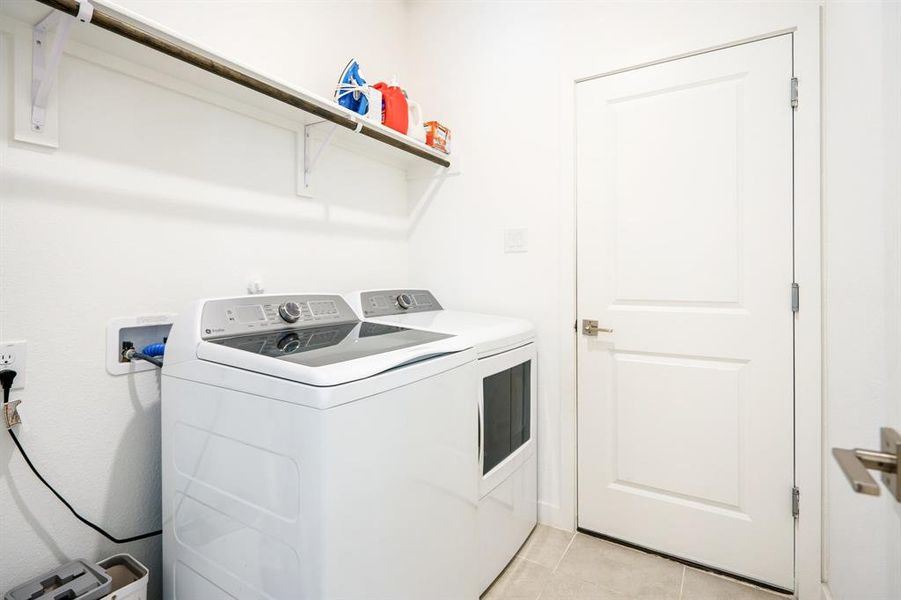 Laundry room with washer & dryer. Connected to the garage