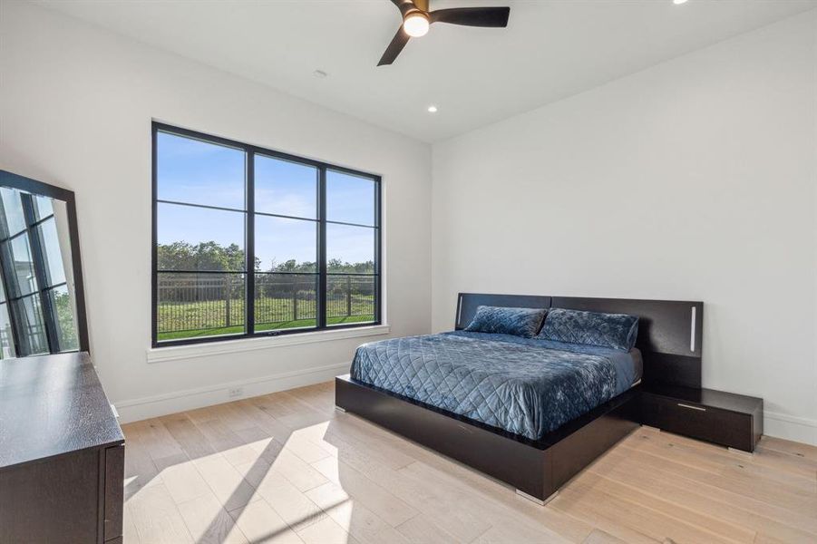 Bedroom with ceiling fan and light hardwood / wood-style floors