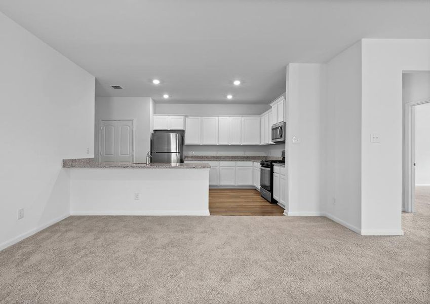 Kitchen with granite countertops and white cabinets