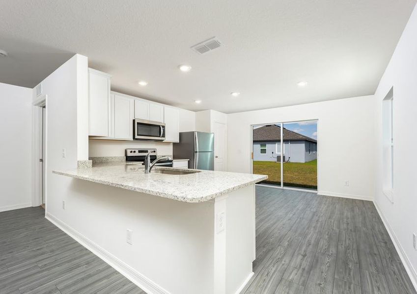 Large granite countertops make the chef-ready kitchen