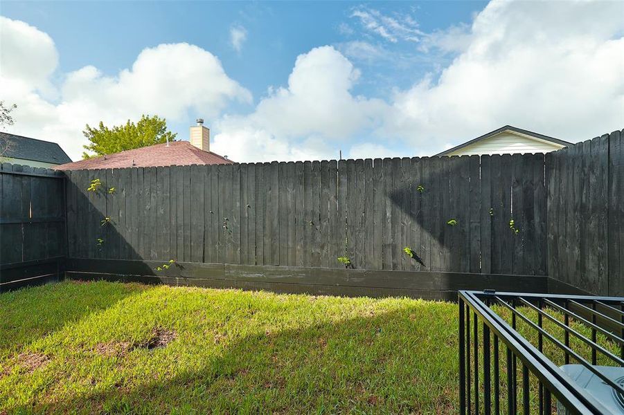 The back yard is fully fenced with an 8-ft high privacy fence