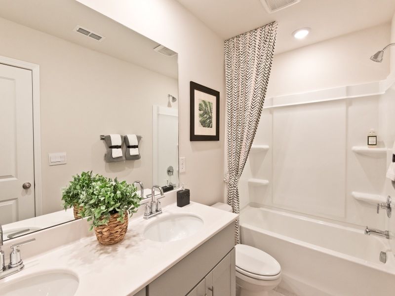 Upstairs secondary bathroom with dual sinks will make mornings a breeze.