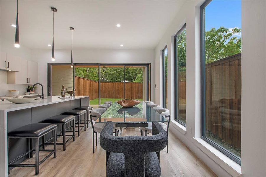 Dining space with light hardwood / wood-style floors