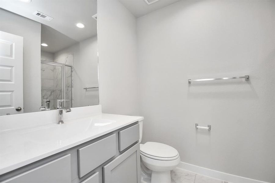 Guest suite with walk in shower. Sample photo of completed home. Actual color and selections may vary.