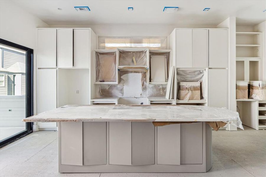 The kitchen on the second level, adjacent to the family room, makes it easy to entertain both inside and outside using the balcony.