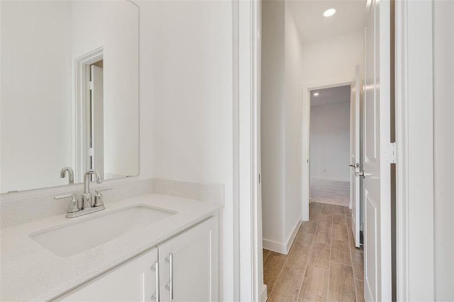 Bathroom with hardwood / wood-style flooring and vanity