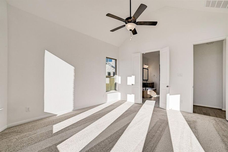 Secondary view of the primary bedroom that leads to the primary bath.