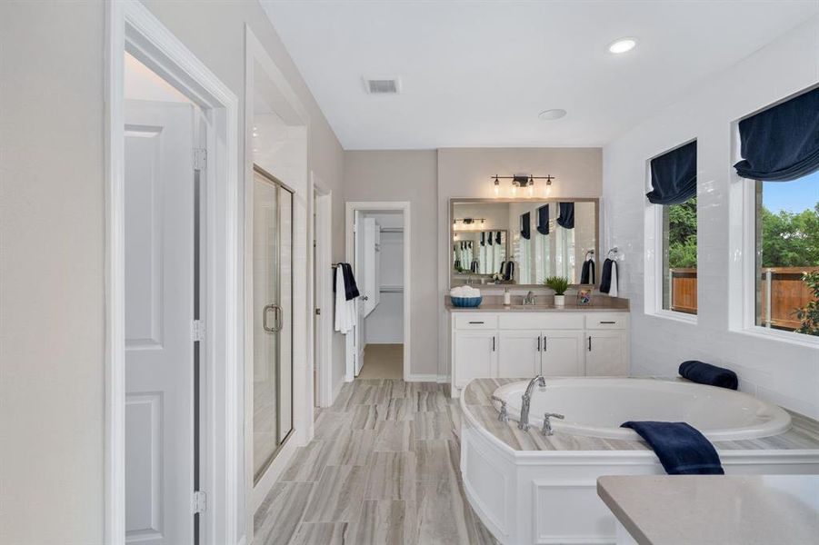 Bathroom with vanity and plus walk in shower