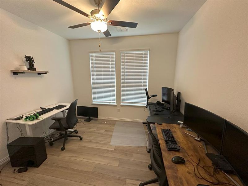 Office space featuring light wood-type flooring and ceiling fan