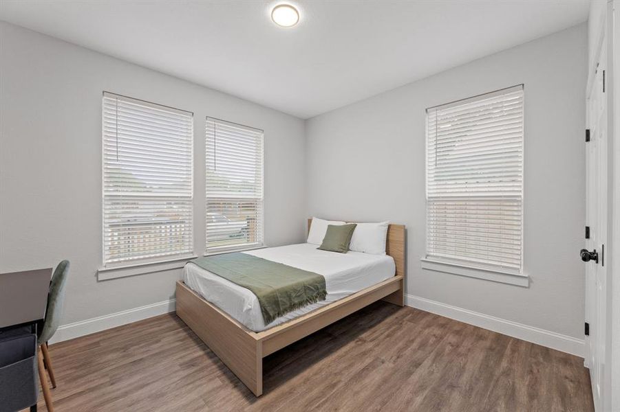 Bedroom with hardwood / wood-style flooring