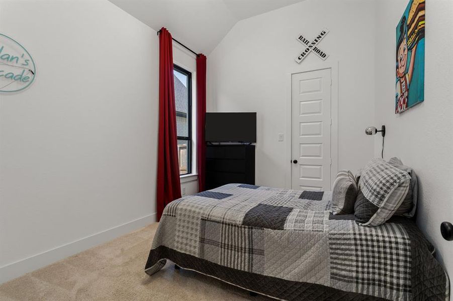 This guest bedroom's high ceilings make the room feel spacious. The walk-in closet offers plenty of space for all of your clothing. This bedroom has it's own ensuite bathroom for added convenience.