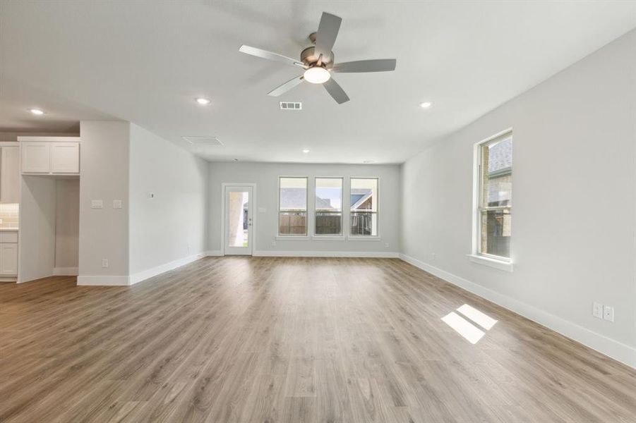 Unfurnished living room featuring light hardwood / wood-style flooring and ceiling fan