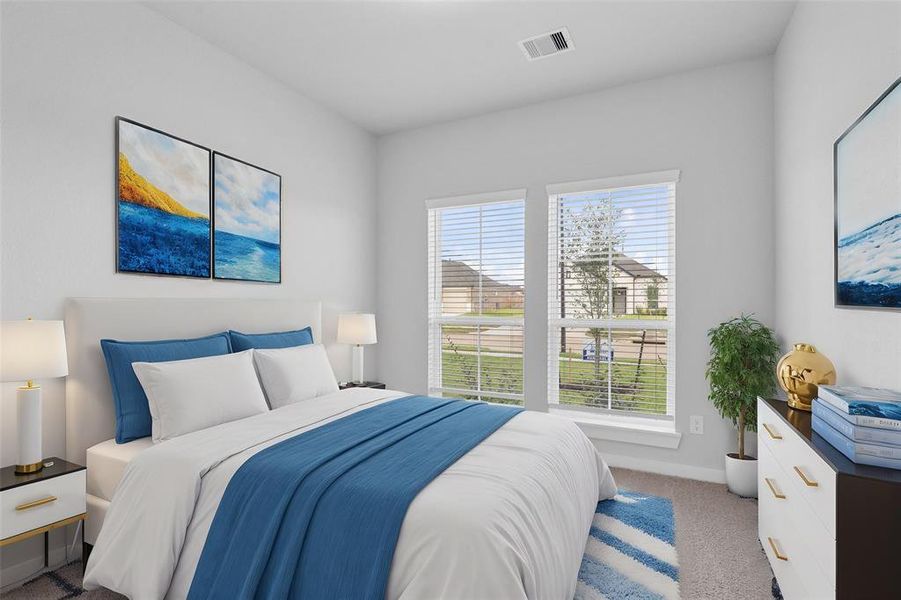 Secondary bedroom features plush carpet, custom neutral paint and a large windows with privacy blinds.