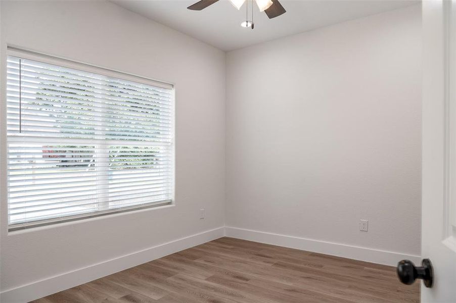 Unfurnished room with hardwood / wood-style flooring and ceiling fan