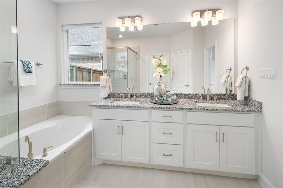 Bathroom featuring vanity, independent shower and bath, and tile patterned floors