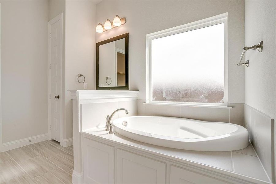 Bathroom featuring a tub to relax in