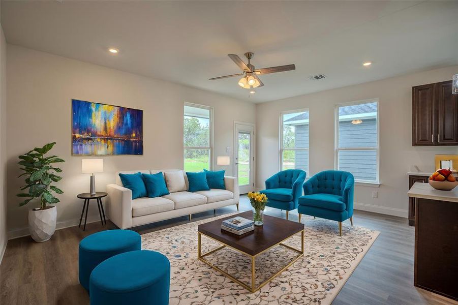 Living room featuring hardwood / wood-style floors and ceiling fan