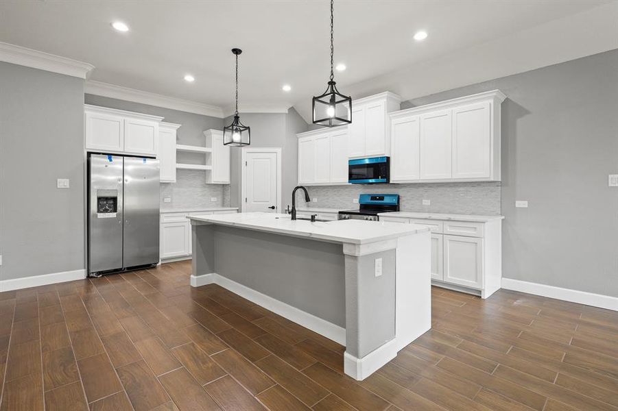 Kitchen featuring white cabinetry, appliances with stainless steel finishes, and dark wood-type flooring