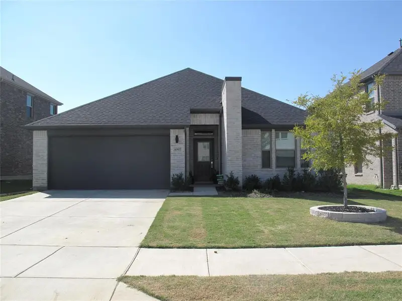 View of front facade with a front yard and a garage