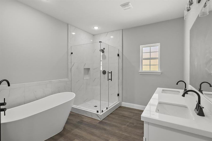 The master bath includes a beautiful soaking tub, dual sinks, and a frameless glass shower.