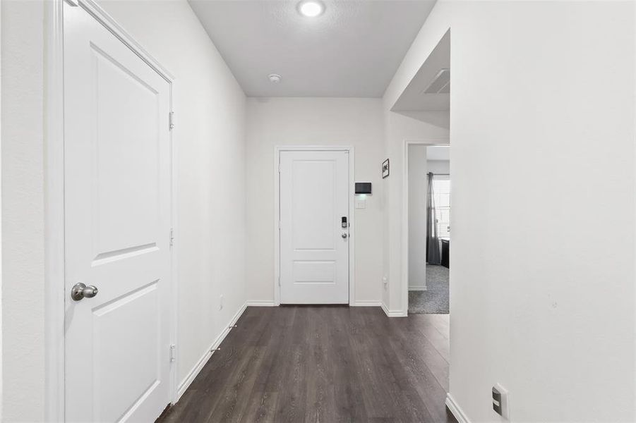 Hall with dark hardwood / wood-style floors