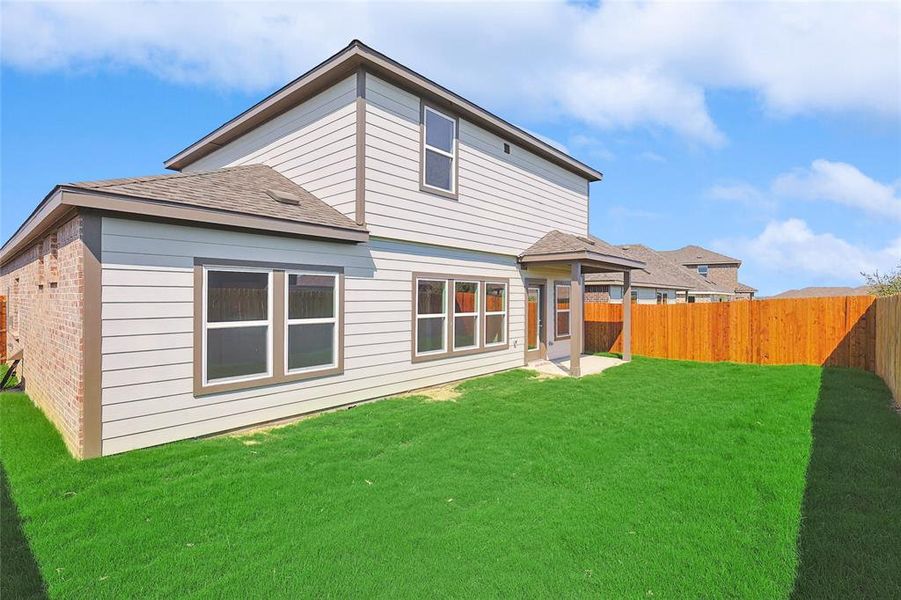 Rear view of house featuring a yard