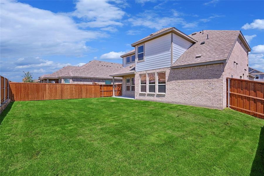 Back of house featuring a yard