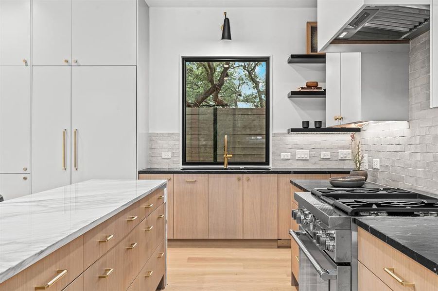 The dual fuel Thermador range, Thermador fridge and freezer columns and massive workstation sink all sit within a few feet of one another for maximum utility and minimal steps. This kitchen is designed to be both beautiful and a workhorse.