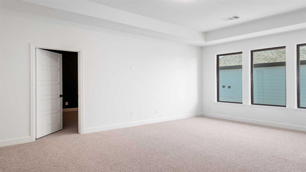 Empty room featuring light colored carpet