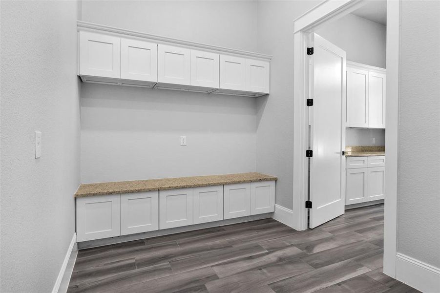 The large MUD room is located just off of the Utility Room and Garage, and offers great storage to hide shoes and backpacks!