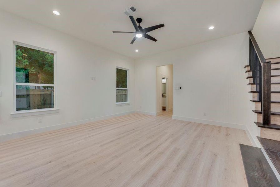 Unfurnished living room featuring light hardwood / wood-style flooring and ceiling fan