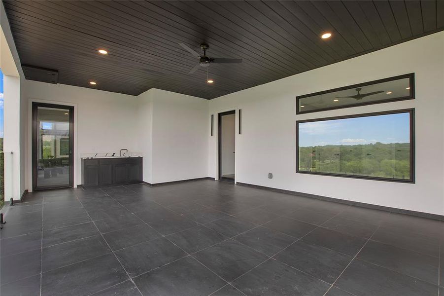 View of patio featuring ceiling fan