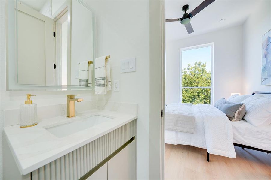 Bathroom with vanity, ceiling fan, and hardwood / wood-style flooring