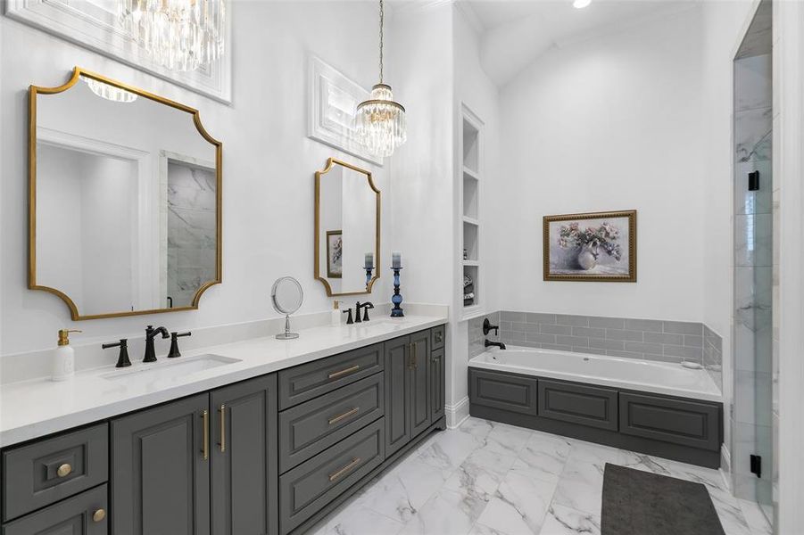 This secondary bath is like a primary bath with double sinks, quartz counters, garden tub, and walk in shower. Precious pendant style light fixtures.