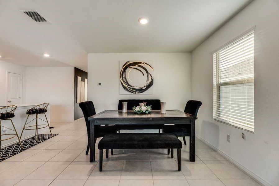 Dining room with light tile patterned flooring