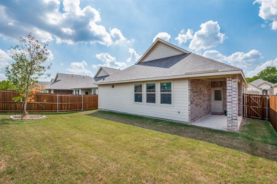 Rear view of house with a yard